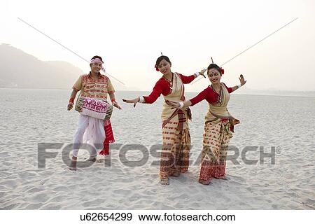 Bihu women dancing as Bihu man plays on a dhol View Large Photo Image Stock Photo - Bihu women dancing as Bihu man plays on a dhol . Fotosearch