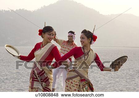 Bihu women dancing with brass plates View Large Photo Image Stock Photo - Bihu women dancing with brass plates . Fotosearch