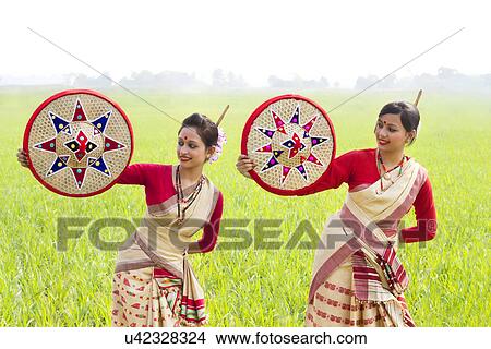 Picture - Bihu women holding jaapis . Fotosearch