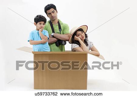 Bored young couple sitting inside cardboard box with little son View Large Photo Image Stock Image - Bored young couple sitting inside cardboard box with little son . Fotosearch