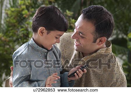 Stock Image - Boy holding a mobile phone . Fotosearch