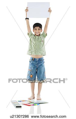 Boy holding a white board View Large Photo Image Stock Photograph - Boy holding a white board . Fotosearch