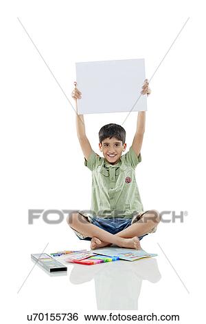 Boy holding a white board View Large Photo Image Stock Photograph - Boy holding a white board . Fotosearch