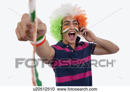 Stock Image - Boy talking on a phone and cheering . Fotosearch