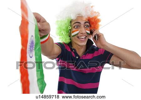 Stock Photo - Boy talking on a phone and cheering . Fotosearch