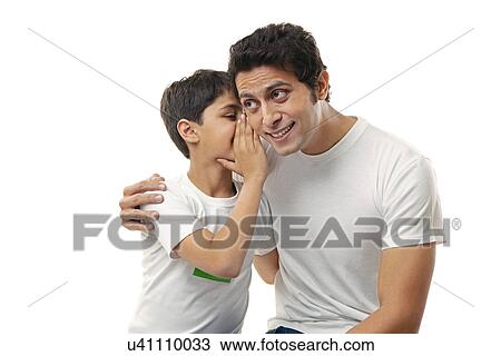 Boy whispering in his fathers ear View Large Photo Image Stock Image - Boy whispering in his fathers ear . Fotosearch