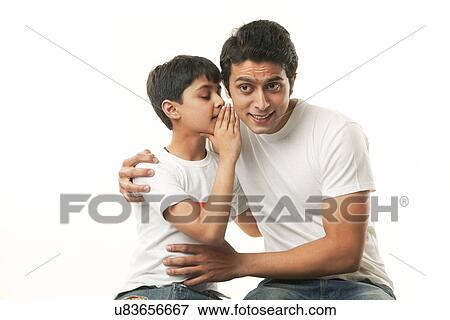 Boy whispering in his fathers ear View Large Photo Image Stock Photo - Boy whispering in his fathers ear . Fotosearch