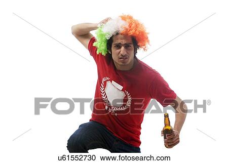 Stock Image - Boy with a wig holding a beer bottle . Fotosearch