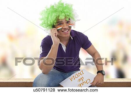 Boy with a wig talking on a mobile phone View Large Photo Image Stock Photo - Boy with a wig talking on a mobile phone . Fotosearch