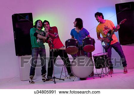 Stock Image - Boys of a rock band enjoying themselves . Fotosearch