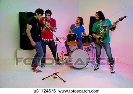 Stock Photograph - Boys of a rock band enjoying themselves . Fotosearch