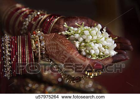 Picture - Bride holding jasmine flower . Fotosearch