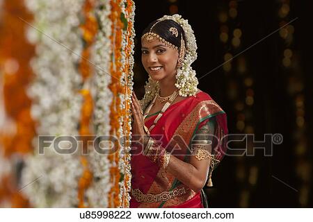 Bride standing by garlands View Large Photo Image Stock Image - Bride standing by garlands . Fotosearch