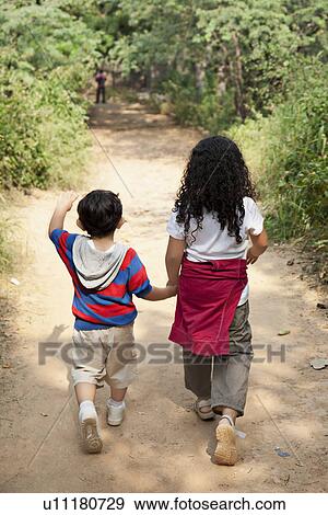 Brother and sister going for a walk View Large Photo Image Stock Photo - Brother and sister going for a walk . Fotosearch