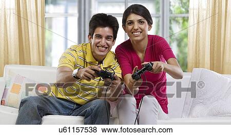 Brother and sister playing video games View Large Photo Image Stock Photo - Brother and sister playing video games . Fotosearch