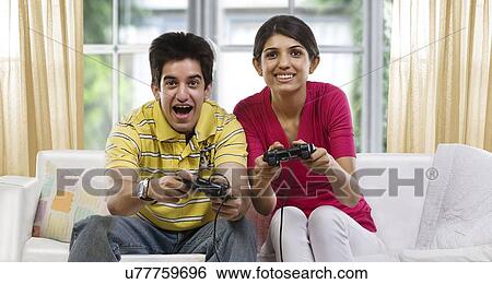 Brother and sister playing video games View Large Photo Image Stock Photograph - Brother and sister playing video games . Fotosearch