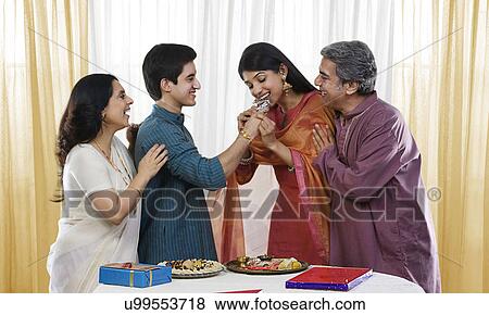 Brother feeding his sister during Rakhi View Large Photo Image Stock Photo - Brother feeding his sister during Rakhi . Fotosearch