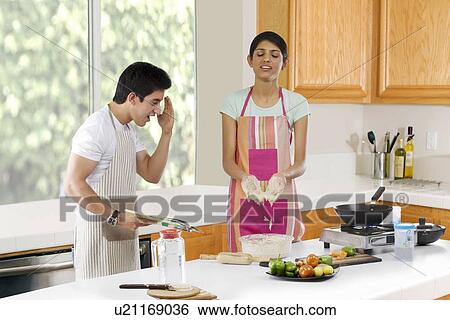 Brother looking at his sisters hands in the kitchen View Large Photo Image Stock Photograph - Brother looking at his sisters hands in the kitchen . Fotosearch