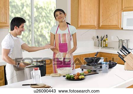 Brother making fun of his sister in the kitchen View Large Photo Image Stock Image - Brother making fun of his sister in the kitchen . Fotosearch