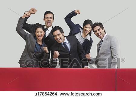 Picture - Business executives cheering during cricket match . Fotosearch