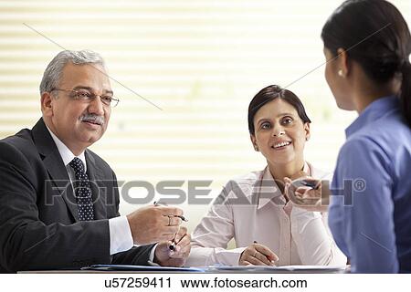 Business executives having a discussion View Large Photo Image Stock Image - Business executives having a discussion . Fotosearch