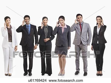 Business executives talking on a mobile phone View Large Photo Image Picture - Business executives talking on a mobile phone . Fotosearch