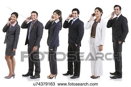 Business executives talking on a mobile phone View Large Photo Image Stock Image - Business executives talking on a mobile phone . Fotosearch