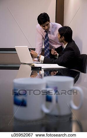Stock Photo - Business executives talking . Fotosearch