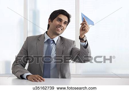 Business man holding paper airplane View Large Photo Image Stock Photo - Business man holding paper airplane . Fotosearch