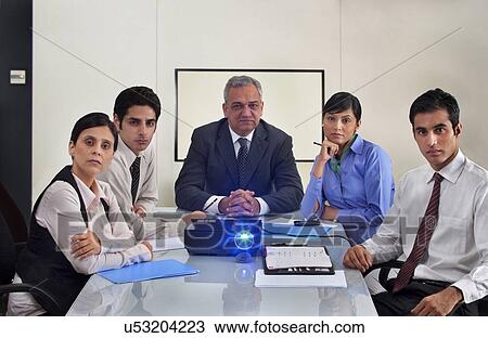 Stock Image - Business people watching a projection presentation . Fotosearch