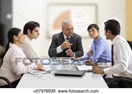 Stock Photo - Business team discussing together in a meeting . Fotosearch