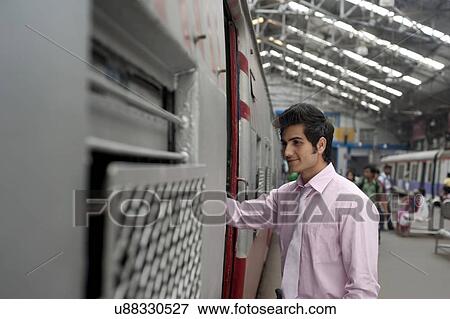 Businessman boarding a train View Large Photo Image Stock Photo - Businessman boarding a train . Fotosearch