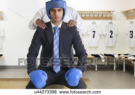 Businessman in boxing gear getting a massage View Large Photo Image Stock Photo - Businessman in boxing gear getting a massage . Fotosearch