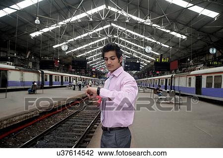 Stock Image - Businessman looking at the time . Fotosearch