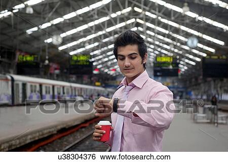 Businessman looking at the time View Large Photo Image Stock Photograph - Businessman looking at the time . Fotosearch