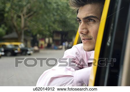Businessman looking out of a taxi View Large Photo Image Stock Image - Businessman looking out of a taxi . Fotosearch