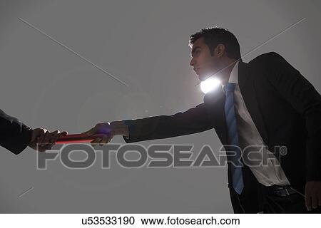 Stock Image - Businessman passing baton . Fotosearch