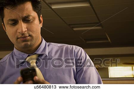 Stock Image - Businessman reading a text message . Fotosearch