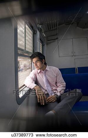 Businessman sitting inside a train View Large Photo Image Stock Image - Businessman sitting inside a train . Fotosearch