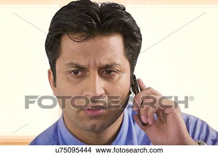 Businessman talking on a mobile phone View Large Photo Image Picture - Businessman talking on a mobile phone . Fotosearch