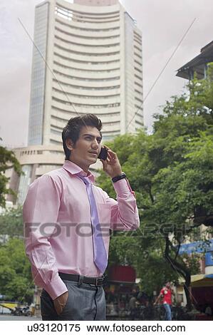 Businessman talking on a mobile phone View Large Photo Image Stock Photography - Businessman talking on a mobile phone . Fotosearch