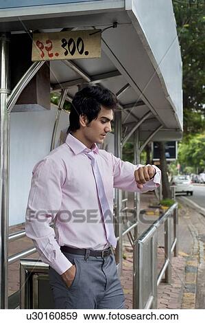 Businessman waiting at a bus stop View Large Photo Image Stock Photo - Businessman waiting at a bus stop . Fotosearch