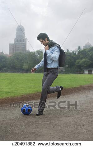 Businessman with a football View Large Photo Image Stock Image - Businessman with a football . Fotosearch