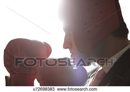 Businessman with boxing gloves in boxing stance View Large Photo Image Stock Image - Businessman with boxing gloves in boxing stance . Fotosearch