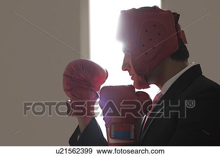 Stock Photo - Businessman with boxing gloves in boxing stance . Fotosearch
