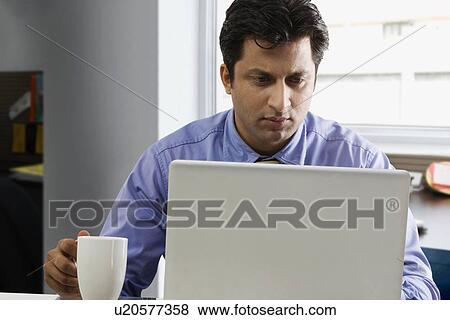 Businessman working on a laptop View Large Photo Image Stock Photo - Businessman working on a laptop . Fotosearch