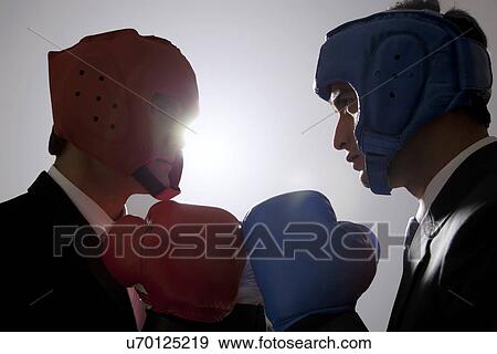 Stock Photo - Businessmen with boxing gloves facing each other . Fotosearch