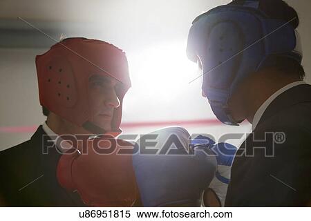 Businessmen with boxing gloves facing each other View Large Photo Image Stock Photography - Businessmen with boxing gloves facing each other . Fotosearch