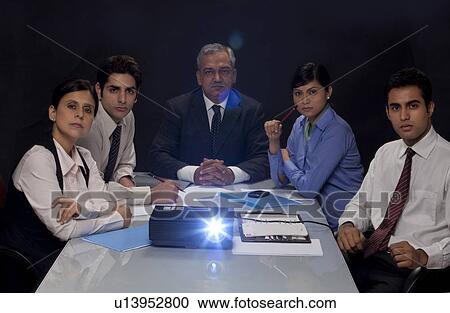 Businesspeople concentrating on projection presentation View Large Photo Image Stock Image - Businesspeople concentrating on projection presentation . Fotosearch