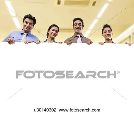Businesspeople holding a placard View Large Photo Image Stock Image - Businesspeople holding a placard . Fotosearch